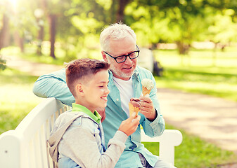 Image showing old man and boy eating ice cream at summer park