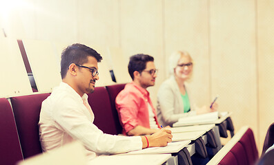 Image showing group of students with notebooks in lecture hall