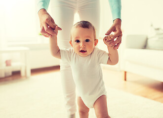 Image showing happy baby learning to walk with mother help