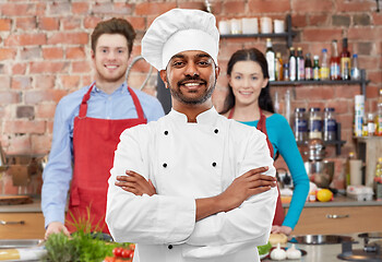 Image showing happy male indian chef in toque at cooking class