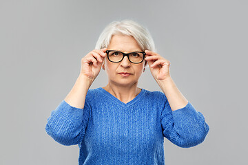 Image showing portrait of senior woman in glasses over grey