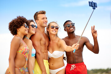 Image showing happy friends taking selfie on summer beach