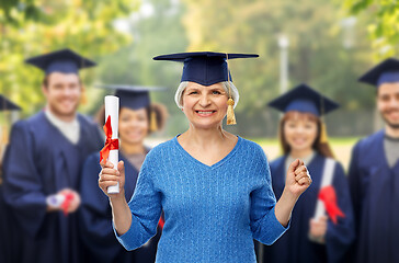 Image showing happy senior graduate student woman with diploma