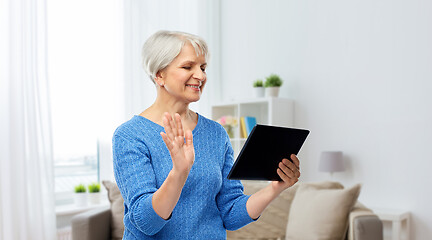 Image showing senior woman having video call on tablet computer