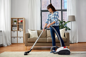 Image showing asian woman with vacuum cleaner at home