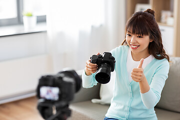 Image showing asian female blogger with camera recording video