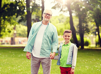 Image showing grandfather and grandson walking at summer park