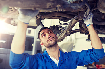 Image showing mechanic man or smith repairing car at workshop