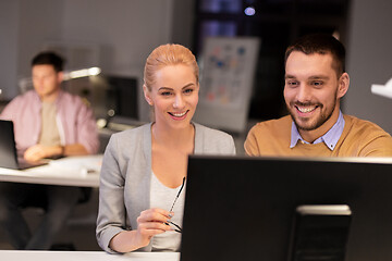 Image showing business team with computer working late at office