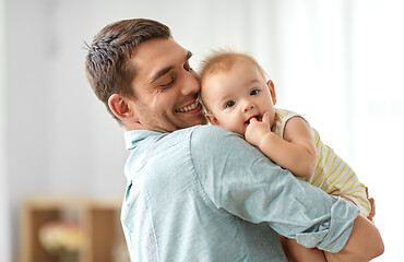 Image showing happy father holding little baby daughter at home