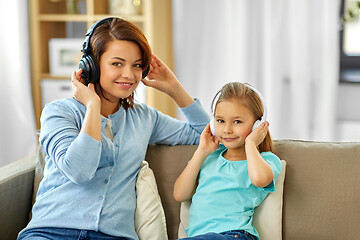 Image showing mother and daughter in headphones listen to music