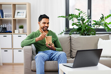 Image showing indian man with laptop eating takeout food at home