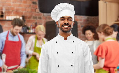 Image showing happy male indian chef in toque at cooking class