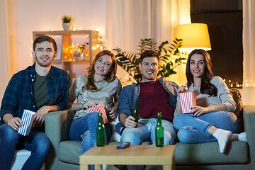 Image showing friends with beer and popcorn watching tv at home