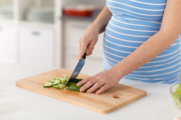 Image showing pregnant woman cooking vegetable salad at home