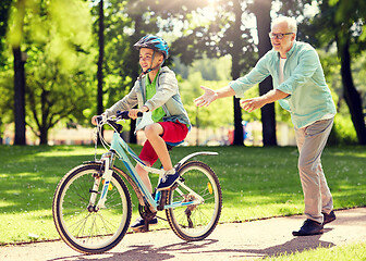 Image showing grandfather and boy with bicycle at summer park