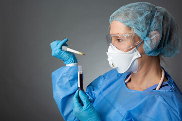 Image showing Laboratory healthcare worker holding a pipette blood sample