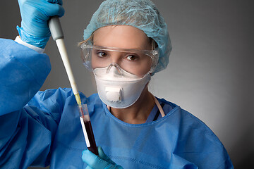 Image showing Laboratory pathologist pipetting a patient blood sample