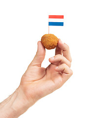 Image showing Single dutch traditional snack bitterbal in a hand