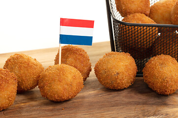 Image showing Dutch traditional snack bitterbal on a serving board, dutch flag