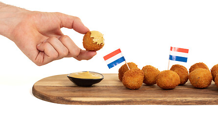 Image showing Dutch traditional snack bitterbal in a hand