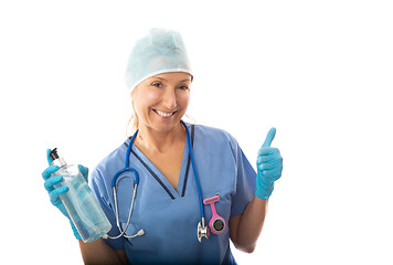 Image showing Healthcare nurse holding a bottle of hand sanitiser and giving t