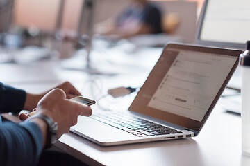 Image showing businessman working using a laptop in startup office