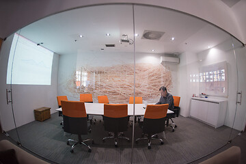 Image showing businessman working using a laptop in startup office