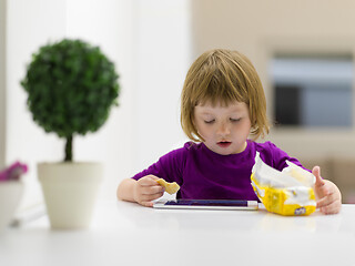 Image showing little girl playing games on tablet computer