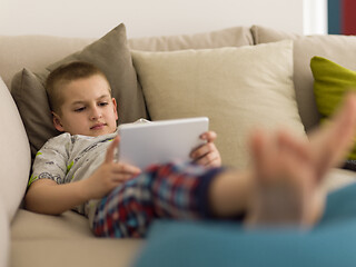 Image showing little boy playing games on tablet computers