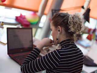 Image showing businesswoman using a laptop in startup office