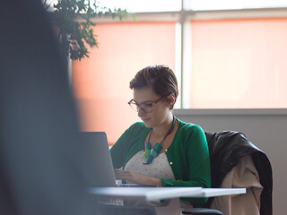 Image showing businesswoman using a laptop in startup office