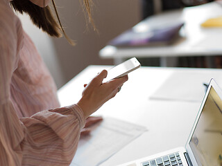 Image showing Businesswoman typing on phone  in office