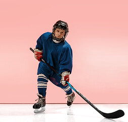 Image showing A hockey player with equipment over a pink background