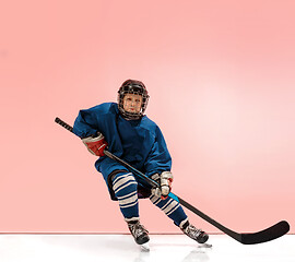 Image showing A hockey player with equipment over a pink background