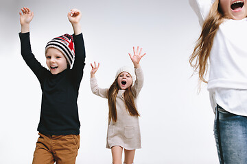 Image showing Group of kids in bright winter clothes, isolated on white