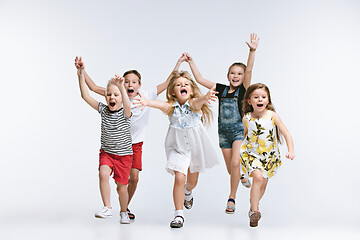 Image showing Group fashion cute preschooler kids friends posing together and looking at camera white background