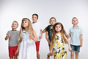 Image showing Group fashion cute preschooler kids friends posing together and looking at camera white background