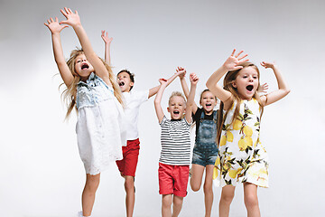 Image showing Group fashion cute preschooler kids friends posing together and looking at camera white background