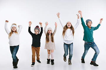 Image showing Group of kids in bright winter clothes, isolated on white