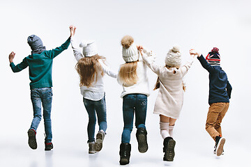 Image showing Group of kids in bright winter clothes, isolated on white