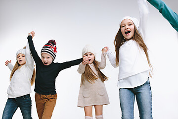 Image showing Group of kids in bright winter clothes, isolated on white