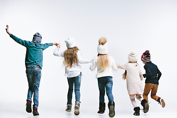 Image showing Group of kids in bright winter clothes, isolated on white