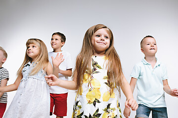 Image showing Group fashion cute preschooler kids friends posing together and looking at camera white background