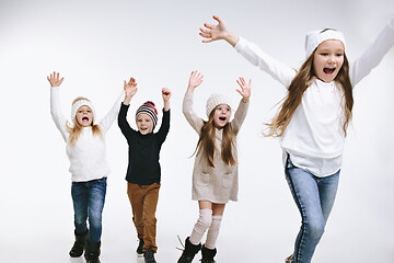 Image showing Group of kids in bright winter clothes, isolated on white