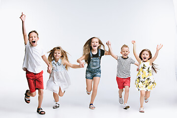 Image showing Group fashion cute preschooler kids friends posing together and looking at camera white background