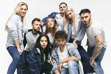 Image showing Group of smiling friends in fashionable jeans