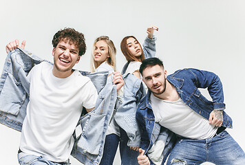 Image showing Group of smiling friends in fashionable jeans