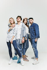 Image showing Group of smiling friends in fashionable jeans