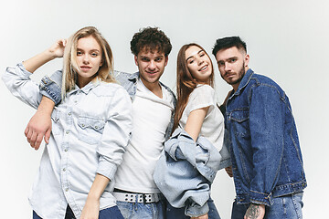 Image showing Group of smiling friends in fashionable jeans